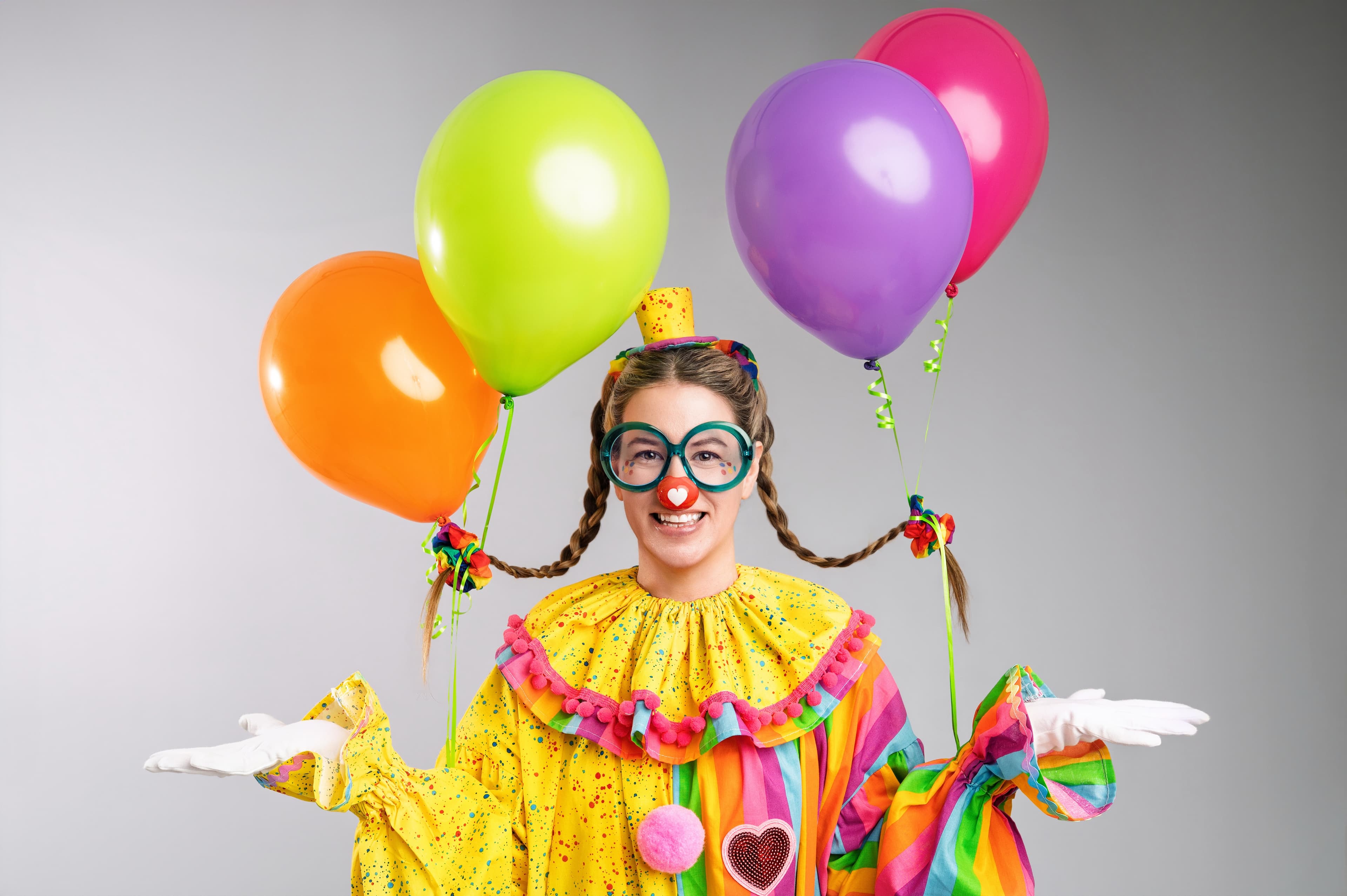 Twinkleheart the Clown holding colourful balloons